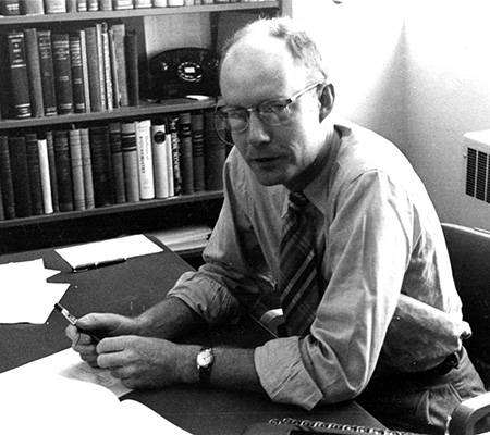 Black & white portrait of Daniel Atkinson in his office, 1952