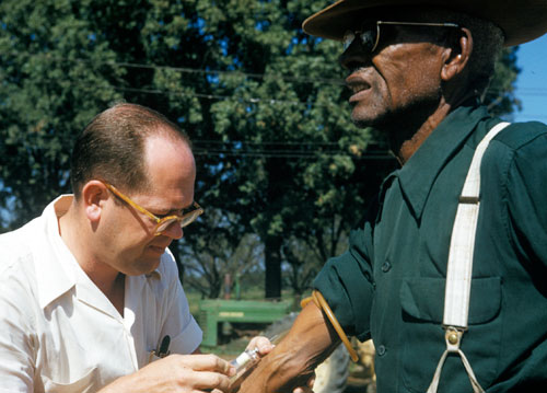 Photo of Tuskegee study subject having blood drawn.
