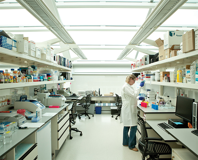 A Van Andel Institute Graduate School student works in a lab.