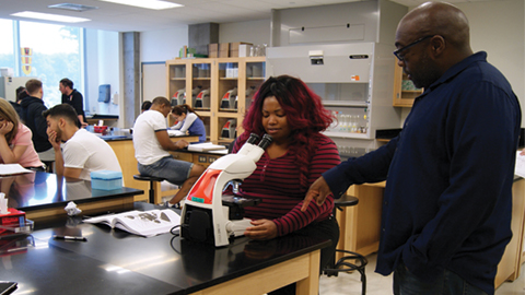 Students at Harbor City Community College draft one-page experimental plans before beginning lab work.