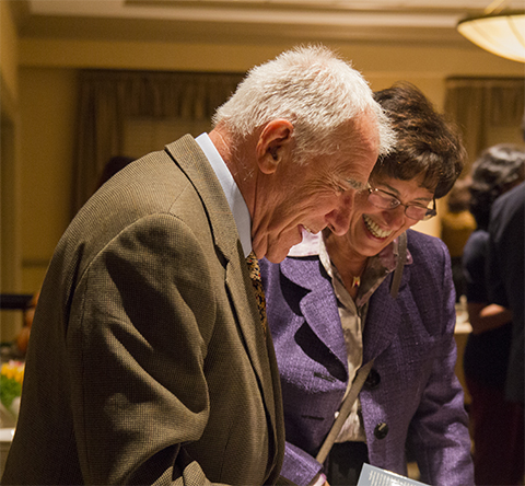 John Exton shares a laugh at an ASBMB celebration with Judith Bond, a former president of the society.