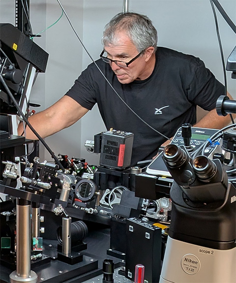 Nobel laureate Eric Betzig works on a Nikon microscope to enable live cell imaging experiments.