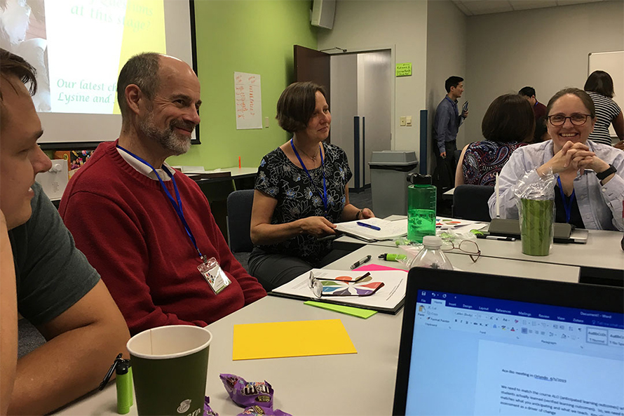 Paul Craig, left, working with faculty at a BASIL CURE workshop to help implement the research-based biochemistry curriculum more broadly across the country.