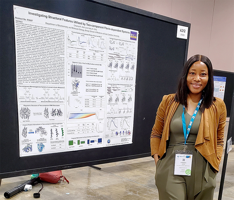 Chiomi Aloh stands in front of her poster at the 2022 ASBMB annual meeting.