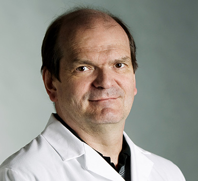 Studio portrait of Krzysztof Palczewski in lab coat