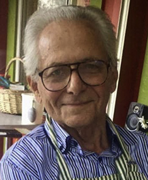 A portrait of German Camejo in the kitchen wearing an apron