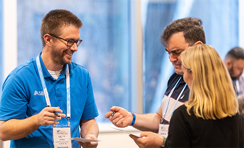 Craig Streu, faculty adviser to the ASBMB Student Chapter at Albion College in Michigan, exchanges notes with Andrew Piefer, Student Chapter adviser at Hartwick College in New York and another attendee during Discover BMB 2023 in Seattle.
