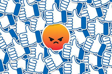 Vector illustration of an angry emoticon amongst a pile of thumbs up.