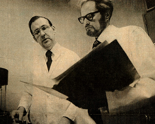 Newspaper photo (1978) of John Brown and John Thurmond looking at papers.