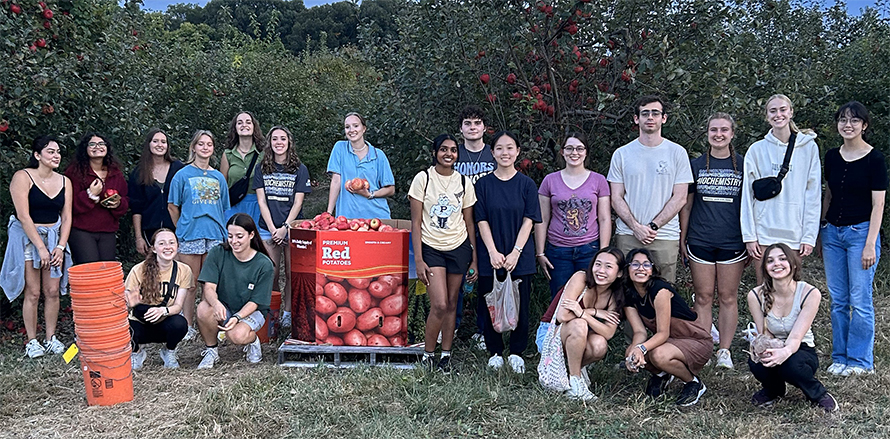 Members of the Purdue ASBMB Student Chapter pose for a group portrait while apple picking in fall 2024. The chapter donated their collected apples to a local food bank.