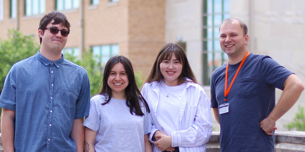 Outdoor group photo of Dustin Fetch, Cameron Chapa, Amina Jumamyradova and Alexey Soshnev.