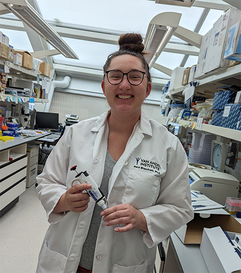 Reid Blanchett tries on her very first lab coat as a new postdoc at the Van Andel Institute in Grand Rapids, Michigan, in 2023.