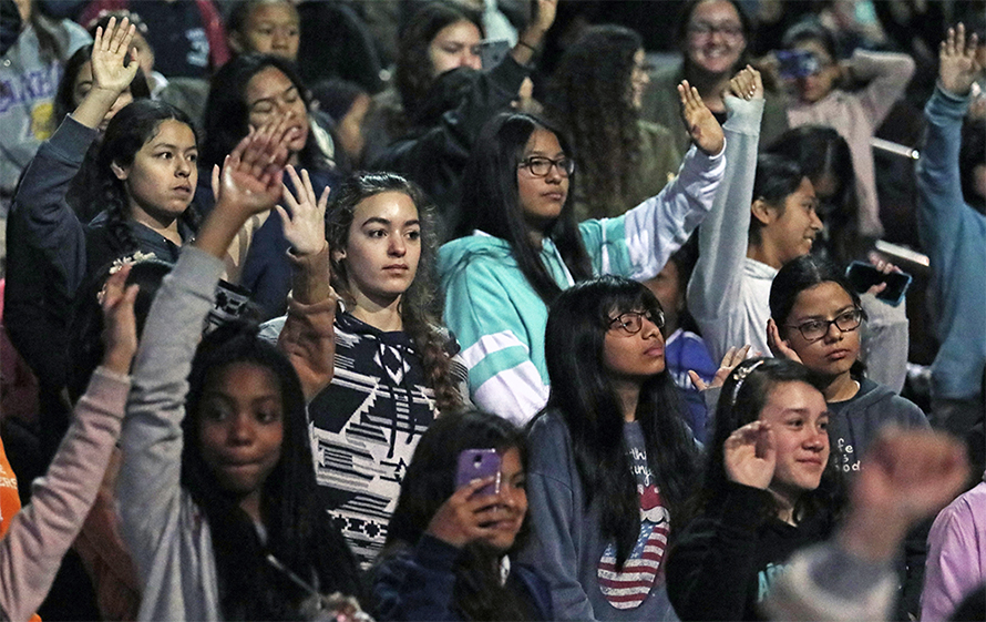 Middle and high school girls from across Los Angeles County raise their hands after musician Pharrell Williams asks whether would consider a career in STEM during a screening of the film "Hidden Figures" at the University of Southern California.