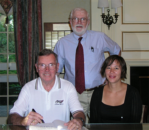 Ralph Bradshaw (standing) with Chuck Hancock and Nicole Kresge at Beaumont House in 2009. The three were the authors of “100 Years of the Chemistry of Life,” a history of the American Society for Biochemistry and Molecular Biology.