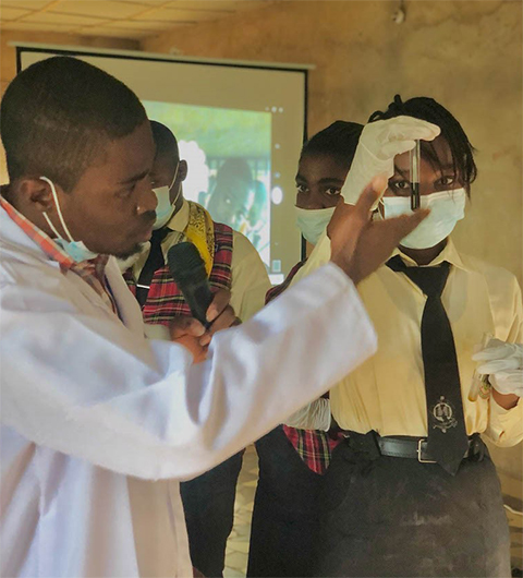 Victor Nweze (left) leads students through a hands-on workshop in the Nsukka community in Nigeria.