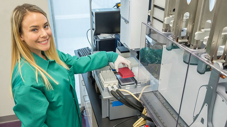 Monica Pruitt works in the lab at the University of Maryland Baltimore County. She has long blond hair.