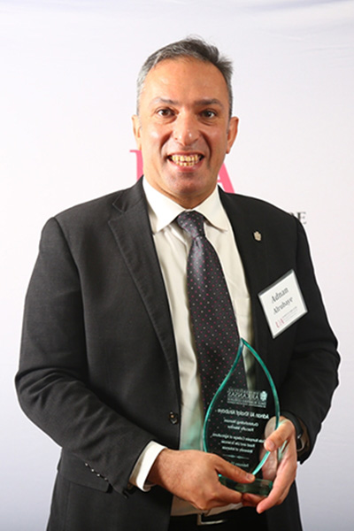 Portrait of Adnan Alrubaye with award