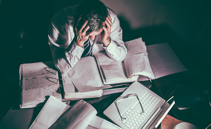 stock photo of pressured scientist at desk