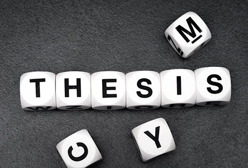 Game cubes spelling the word 'thesis'