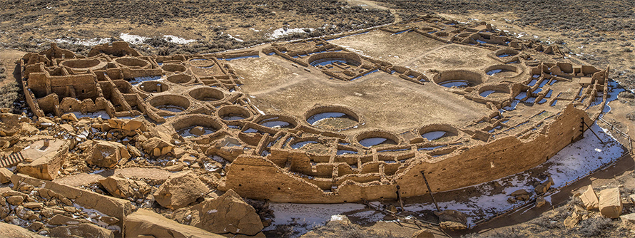 Pueblo Bonito was the largest of more than a dozen, multistoried masonry buildings, referred to as great houses, in Chaco Canyon, New Mexico. The structure was five stories high and held more than 650 rooms. Constructed by ancestral Puebloan peoples, this was the center of the Chacoan world. The site has been studied since the late 19th century. More recently, geneticists have studied the DNA of human remains found here, though the ethics of this research has been questioned because of — among other things — the lack of tribal consultation.