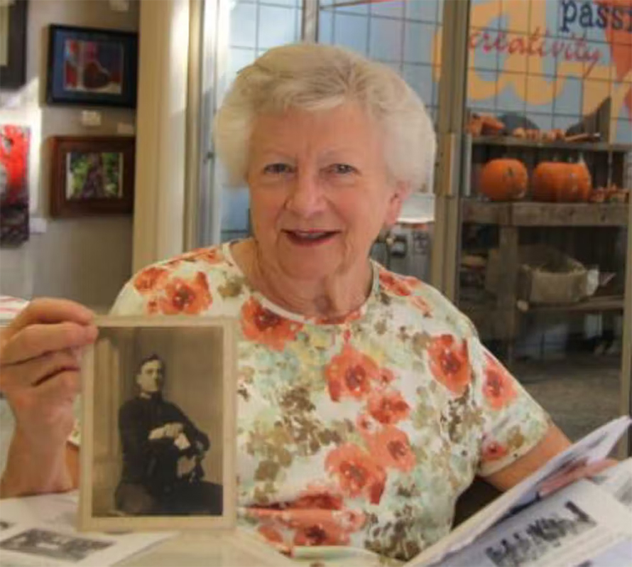 Sheila LeBlanc holding photo of her father, Albert Alexander, in 2012.