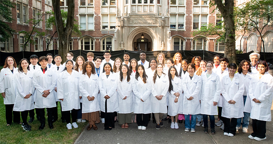 The 2023 Aspirnaut summer research interns, flanked by the program’s co-founders, Julie Hudson, MD, left, and Billy Hudson, PhD, back row, right.