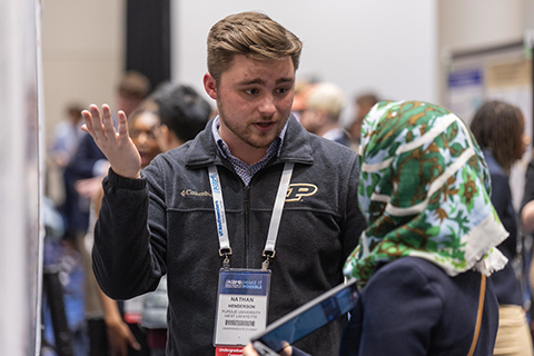 Nathan Henderson, a recent graduate of Purdue University, discusses his research with Mona Al–Mugotir, an instructor at the University of Nebraska–Lincoln and ASBMB Membership Committee member, at ASBMB 2025.