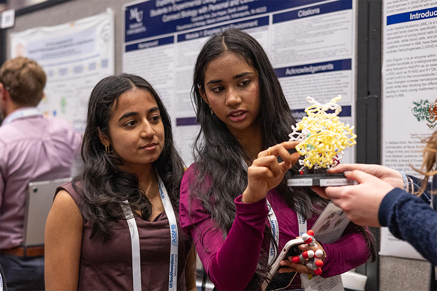 Undergraduates Bhumika Balani and Nitya Punjal of Nova Southeastern University examine a 3D protein model at ASBMB’s 2025 annual meeting in Chicago.