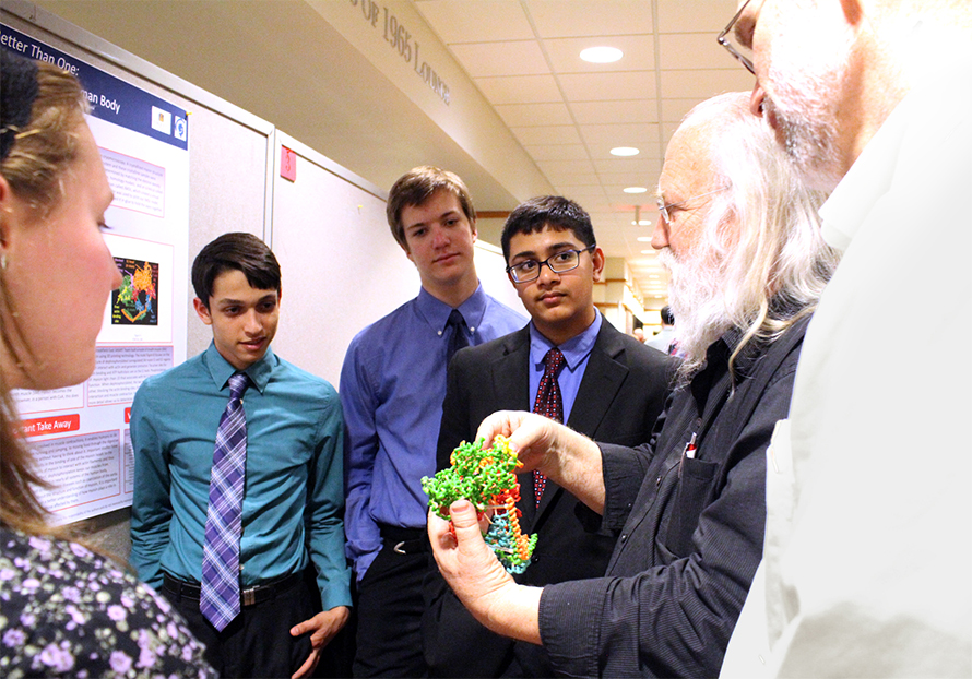 SMART Team program founder Tim Herman, second from right, talks protein molecules with students from Governor's Academy of Byfield, Massachusetts in April 2016.