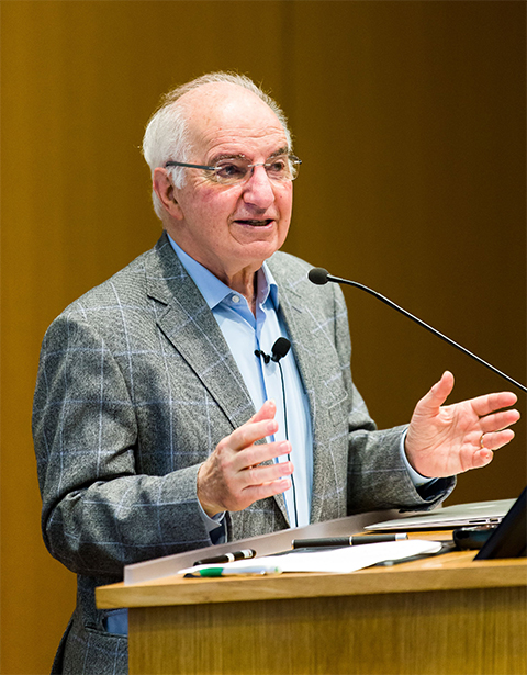 Fred Goldberg gestures at the podium.