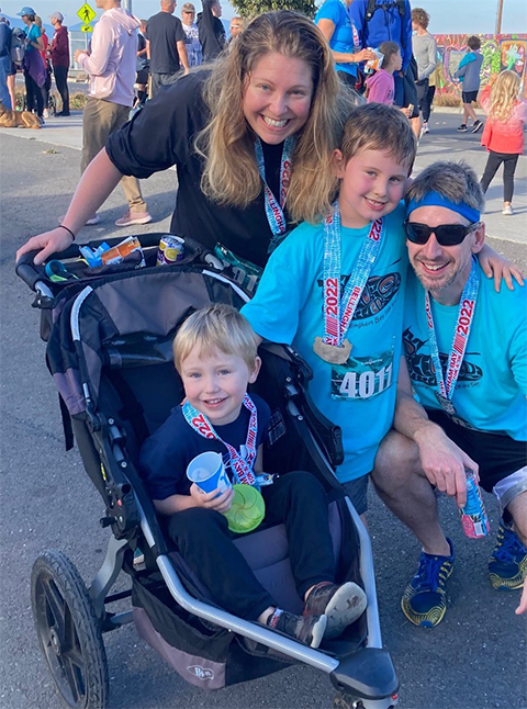 Jeanine Amacher and her family at the finish line of a recent 5K race, one day after her older son turned 6.