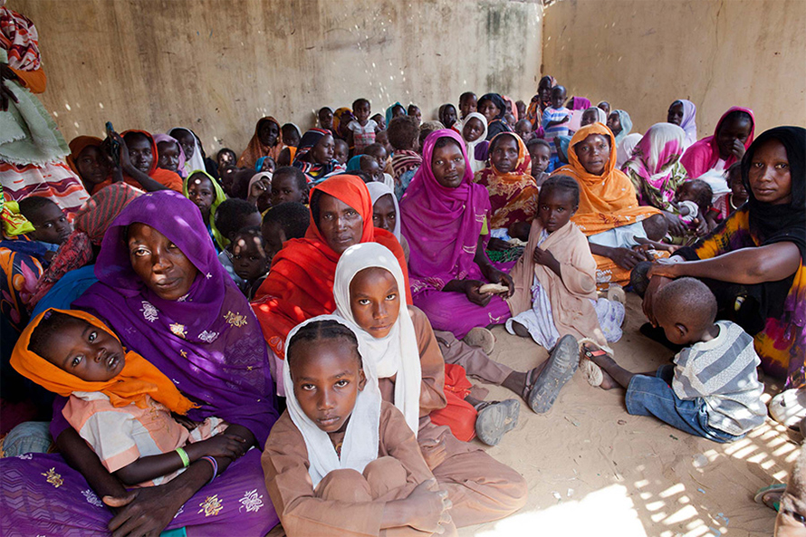 Many poorer regions of the world lack easy access to vaccination. (Here, children in Darfur wait to receive a meningitis vaccine.) This can prevent people from being fully protected, since many vaccines require multiple doses for full effect. A technology now under development for self-boosting vaccines may allow people to get their full series of doses in a single injection.